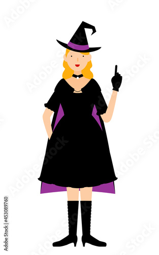 ハロウィンの仮装、魔女姿の女性が指さしをするポーズ