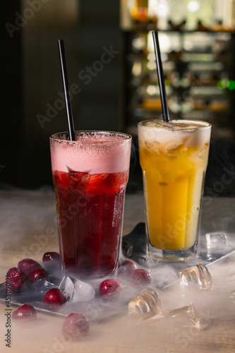 Wallpaper Mural Fresh cocktails with cherry and pineapple in glasses with straws served on slate board on counter with smoke in nightclub  Torontodigital.ca