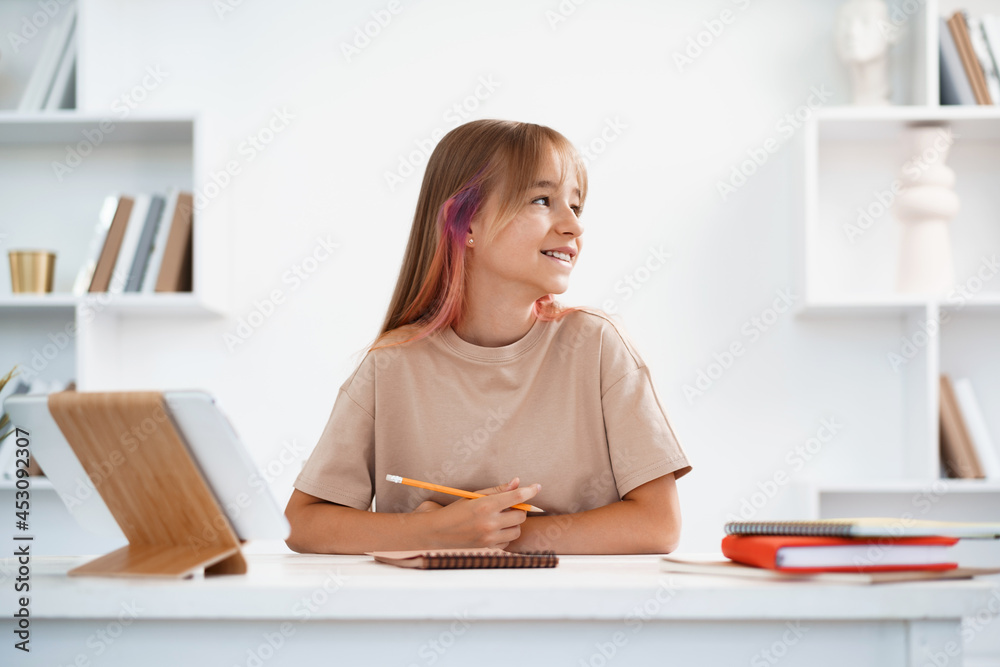 Portrait of a little girl using digital tablet computer at home. Portrait of a little girl using digital tablet computer at home.
