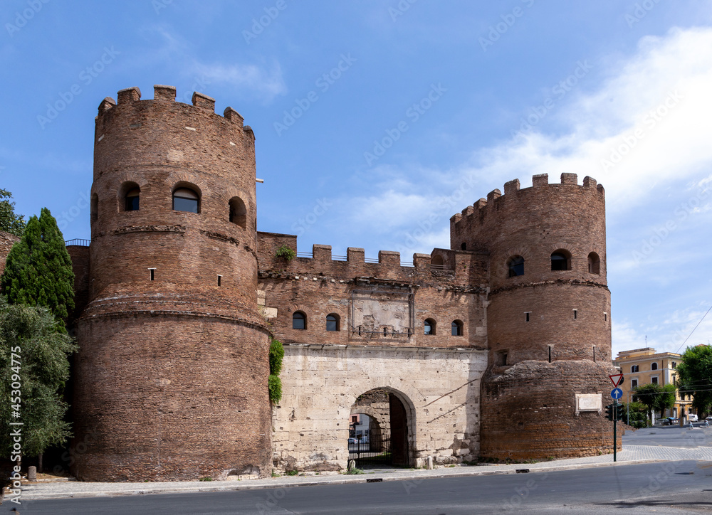 Porta Asinaria, a gate in the Aurelian Walls of Rome,Italy. It was a simple gate,but Honorius added two semi-cylindrical towers to increase its resistance to the probable attacks of enemies Porta Asinaria, a gate in the Aurelian Walls of Rome,Italy. It was a simple gate,but Honorius added two semi-cylindrical towers to increase its resistance to the probable attacks of enemies