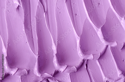 Purple clay (alginate face mask, body wrap, hair shampoo, conditioner) texture close up, selective focus. Abstract lavender background with brush storkes. © kazmulka