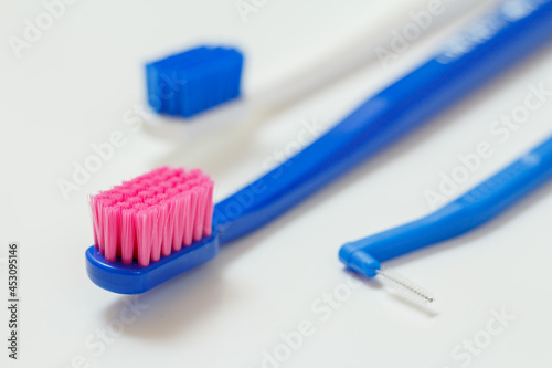 Toothbrushes and interdental brush on the white background.