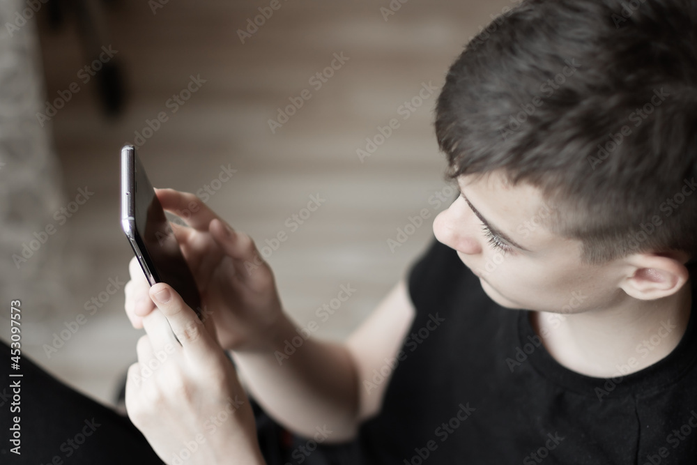 Selective focus to hands of teenager using mobile technology. Selective focus to hands of teenager using mobile technology.