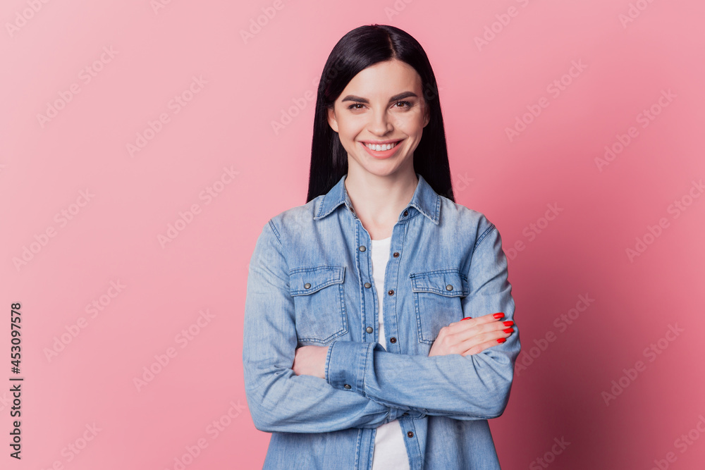 Close-up portrait of yong woman happy positive smile confident folded hands isolated over pink color background Close-up portrait of yong woman happy positive smile confident folded hands isolated over pink color background