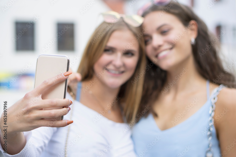 two young women making smiling head to head a selvy two young women making smiling head to head a selvy