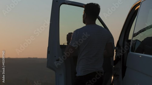The man gets out of the car on the beautiful mountain top. slow motion