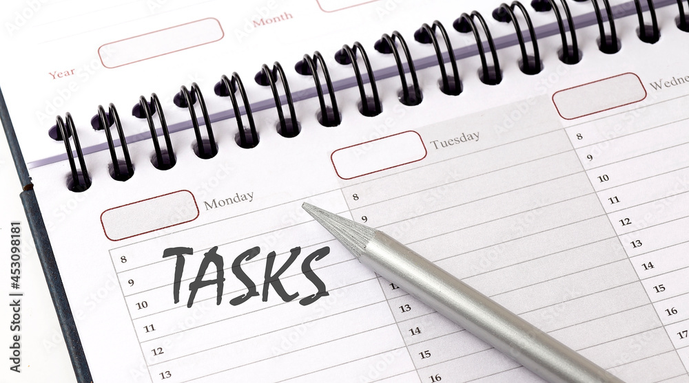 TASKS on the planner with pencil, business concept TASKS on the planner with pencil, business concept