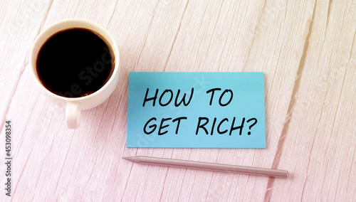 HOW TO GET RICH text on the blue sticker with cofee and pen