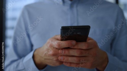 Smartphone in business man hands. Closeup businessman hands using mobile phone