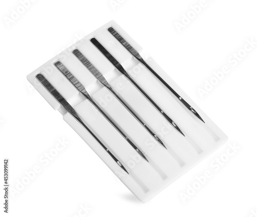 Set of metal needles for sewing machine on white background