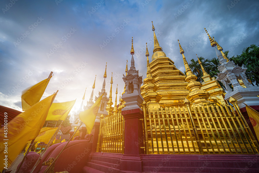 Fototapeta premium Beautiful Ancient golden color Pagoda in the Phan Tao temple is a Buddhist temple in the historic centre tourist attraction an ancient Thai art and is Public places in Chiang Mai,Thailand.
