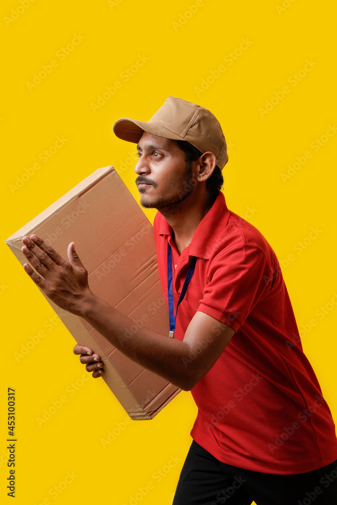 Happy Asian man in t-shirt and cap holding empty box isolated over white background, Delivery service concept Happy Asian man in t-shirt and cap holding empty box isolated over white background, Delivery service concept