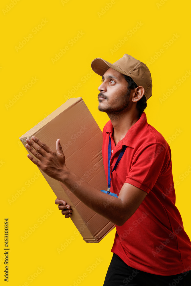 Happy Asian man in t-shirt and cap holding empty box isolated over white background, Delivery service concept Happy Asian man in t-shirt and cap holding empty box isolated over white background, Delivery service concept