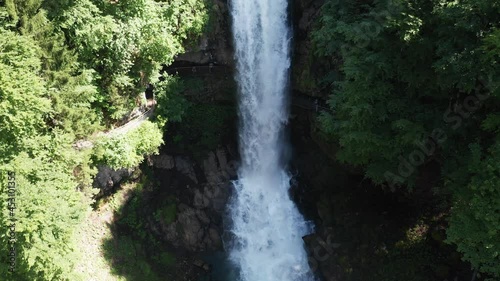 waterfall in swiss alps forest from aerial view in 4k photo