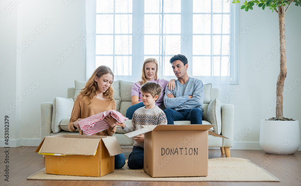 Portrait of volunteer caucasian family couple of parents, daughter and son putting belonging in cardboard box. Family leisure activities donation boxes, happy together concept. Portrait of volunteer caucasian family couple of parents, daughter and son putting belonging in cardboard box. Family leisure activities donation boxes, happy together concept.