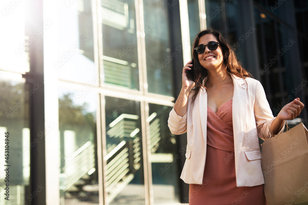 Young beautiful businesswoman using the phone. Female manager talking to the phone Young beautiful businesswoman using the phone. Female manager talking to the phone