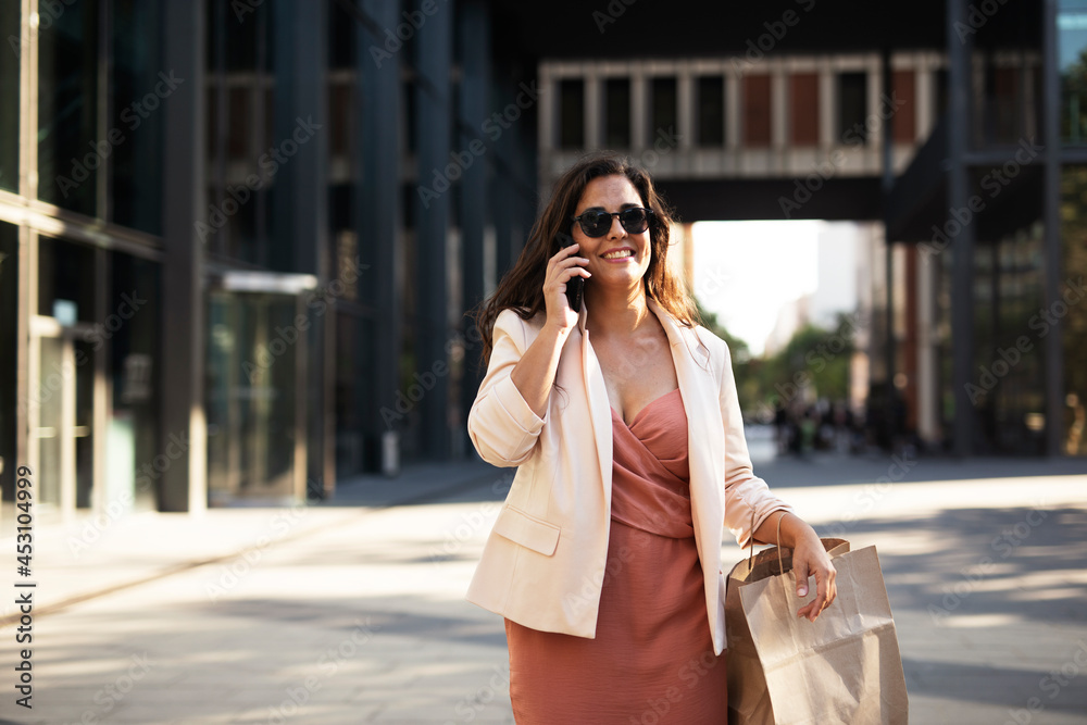Young beautiful businesswoman using the phone. Female manager talking to the phone
