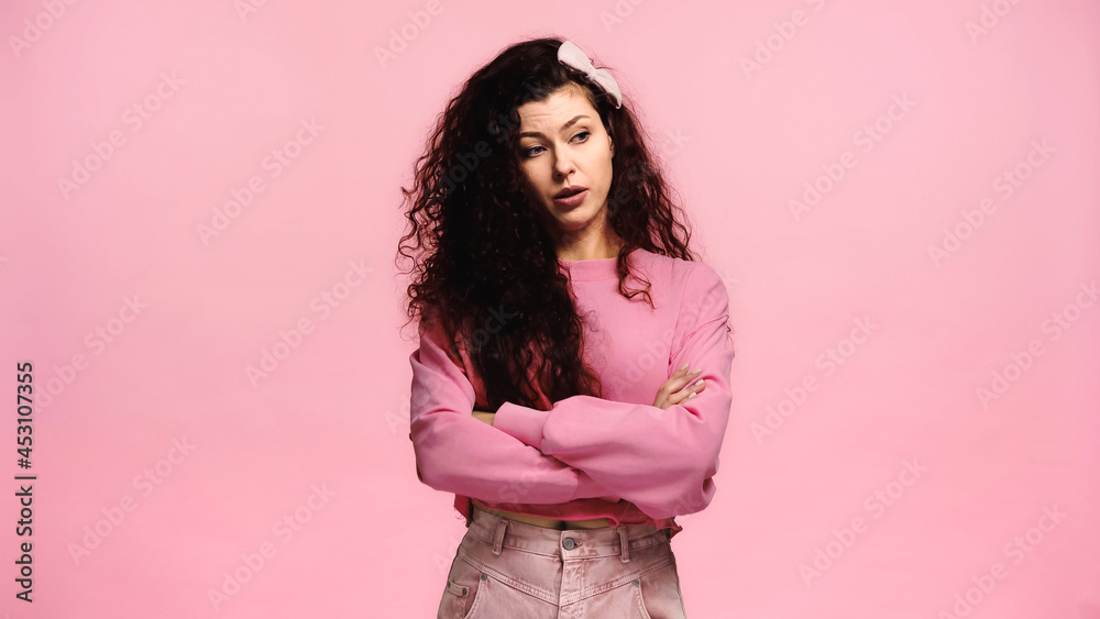 upset woman with crossed arms looking away isolated on pink upset woman with crossed arms looking away isolated on pink