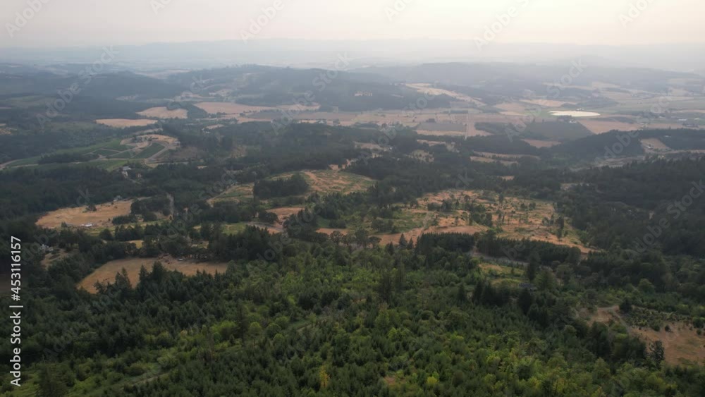 Aerial view of forested moountain area, smoke in the distant sky from forest fires Aerial view of forested moountain area, smoke in the distant sky from forest fires