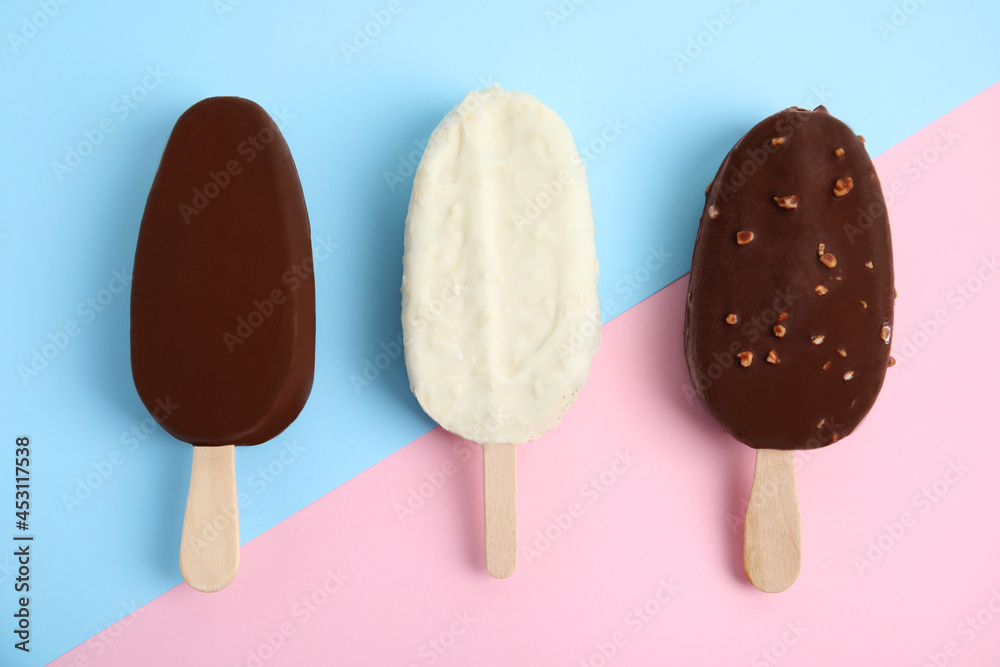 Glazed ice cream bars on color background, flat lay Glazed ice cream bars on color background, flat lay