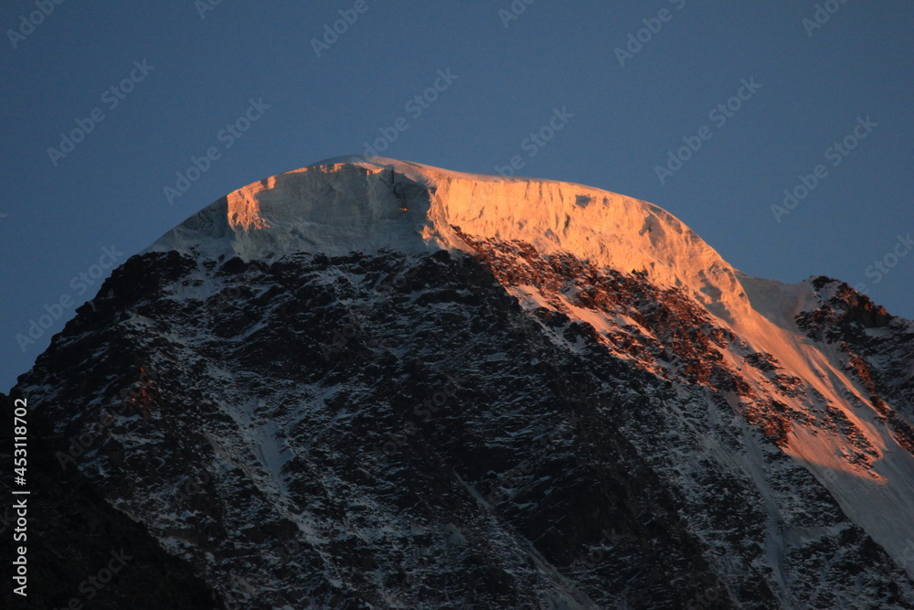 Glacier on top of Donguz-Orun mountain at sunset