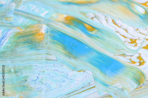 art photography of abstract marbleized effect background with white, blue and yellow reative colors. Beautiful paint.