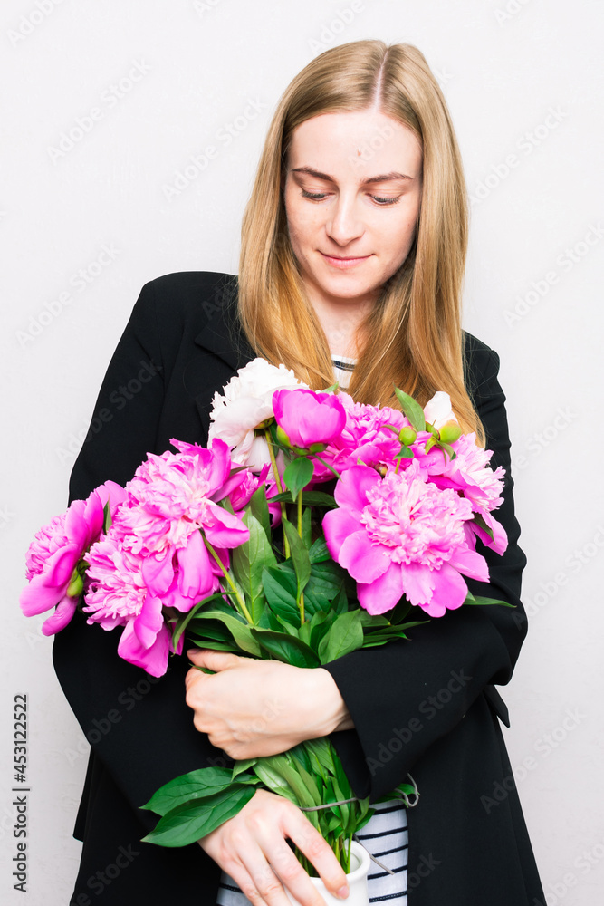 Beautiful woman holding a bouquet of fresh flowers Beautiful woman holding a bouquet of fresh flowers