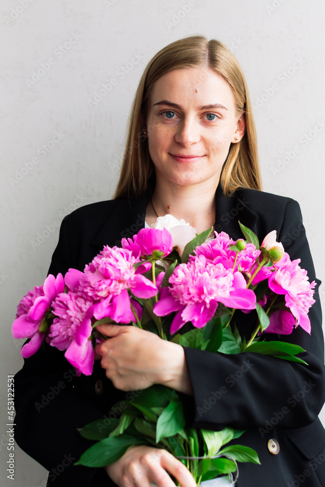 Beautiful woman holding a bouquet of fresh flowers Beautiful woman holding a bouquet of fresh flowers