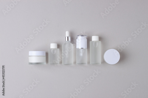 Skin care products on grey background. Flat lay, composition.