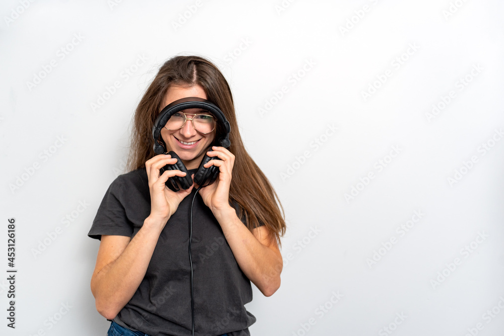 Young latin woman with headphones against white background Young latin woman with headphones against white background