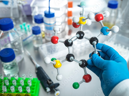 Scientist holding molecular model in laboratory
