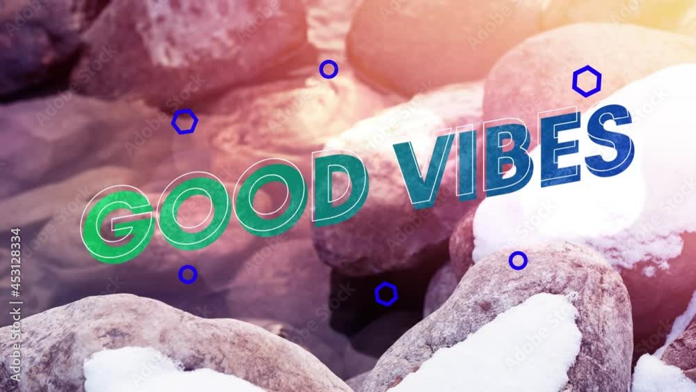Animation of good vibes text over stones cover with snow