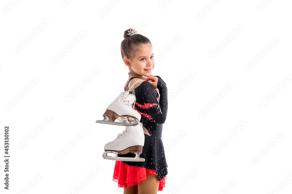Portrait of a little girl figure skater with skates in her hands showing gesture of success Portrait of a little girl figure skater with skates in her hands showing gesture of success
