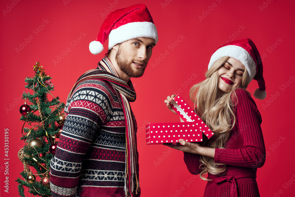 man and woman Christmas tree toys gifts holiday red background man and woman Christmas tree toys gifts holiday red background