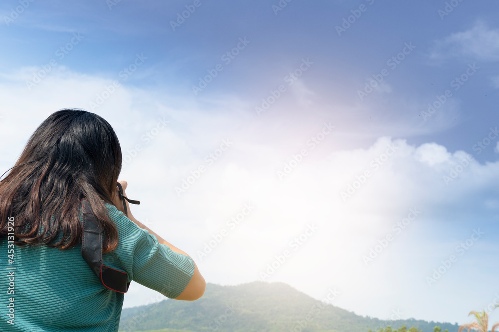 Rear side of women take photography to nature of mountain and blue sky on day time. Rear side of women take photography to nature of mountain and blue sky on day time.