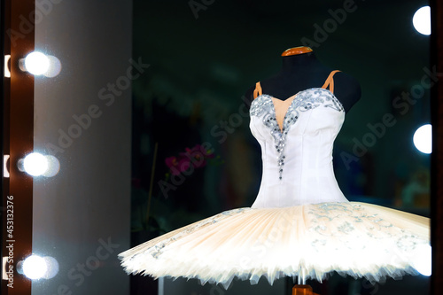 White ballet tutu on display for sale in ballet store accessory. Professional tutu and costume, showcase of ballet accessories shop.