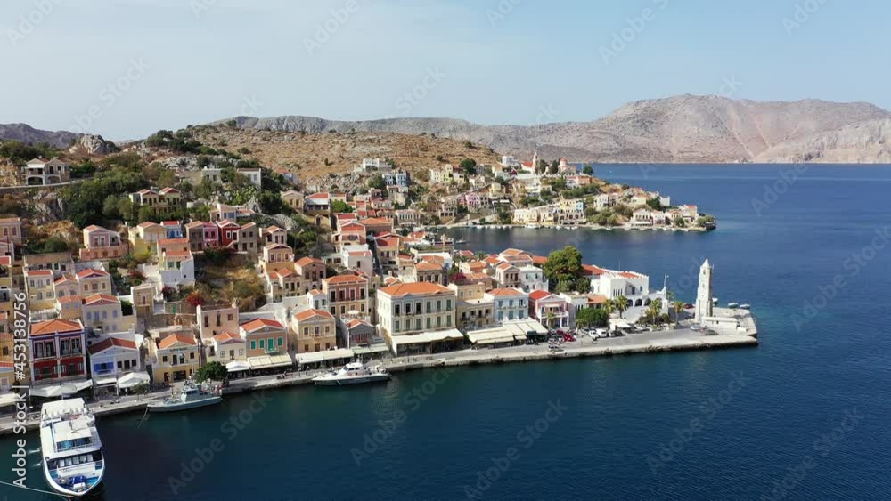 View on Symi (Simi) island harbor port, classical ship yachts, houses on island hills, Aegean Sea bay. Greece islands holidays vacation travel tours from Rhodos island. Symi, Greece, Dodecanese. View on Symi (Simi) island harbor port, classical ship yachts, houses on island hills, Aegean Sea bay. Greece islands holidays vacation travel tours from Rhodos island. Symi, Greece, Dodecanese.