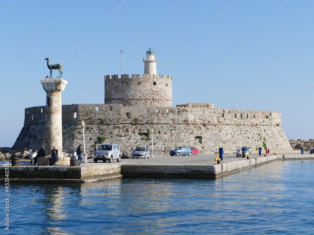 The hind Elafina and the port fortress Agios Nikolaos at the Mandraki harbor in Rhodes Town, Rhodes, Greece