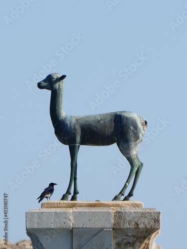 The port entrance of the Mandraki Harbor in Rhodes Town, Rhodes, Greece is guarded by a deer (Elafos) and a hind (Elafina