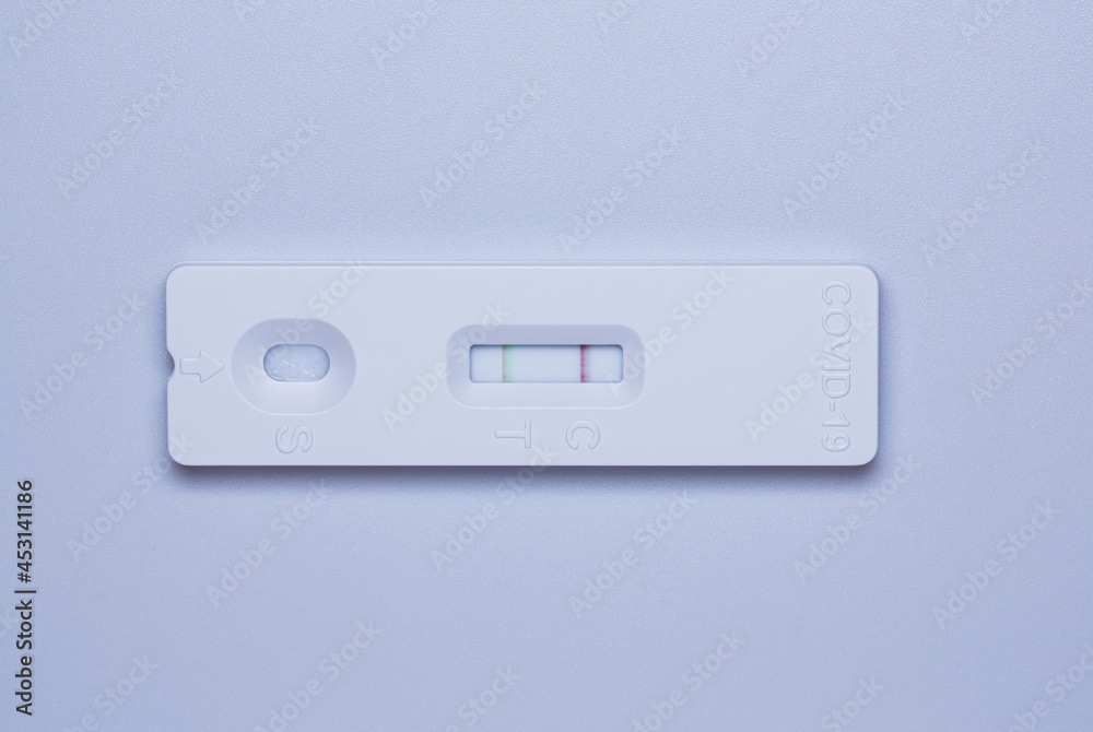 Coronavirus covid19 Ag positive test. Close-up of COVID-19 Antigen Rapid Test on white background. Coronavirus covid19 Ag positive test. Close-up of COVID-19 Antigen Rapid Test on white background.