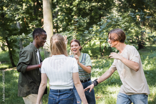 Positive interracial teen friends having fun outdoors © LIGHTFIELD STUDIOS