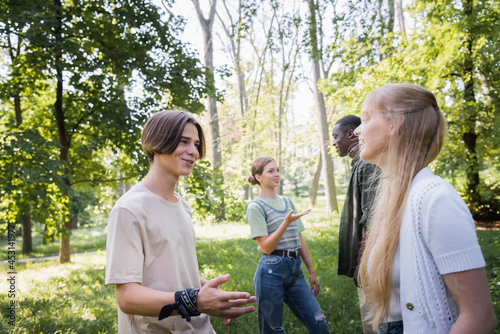Teen friends talking while spending time in park © LIGHTFIELD STUDIOS