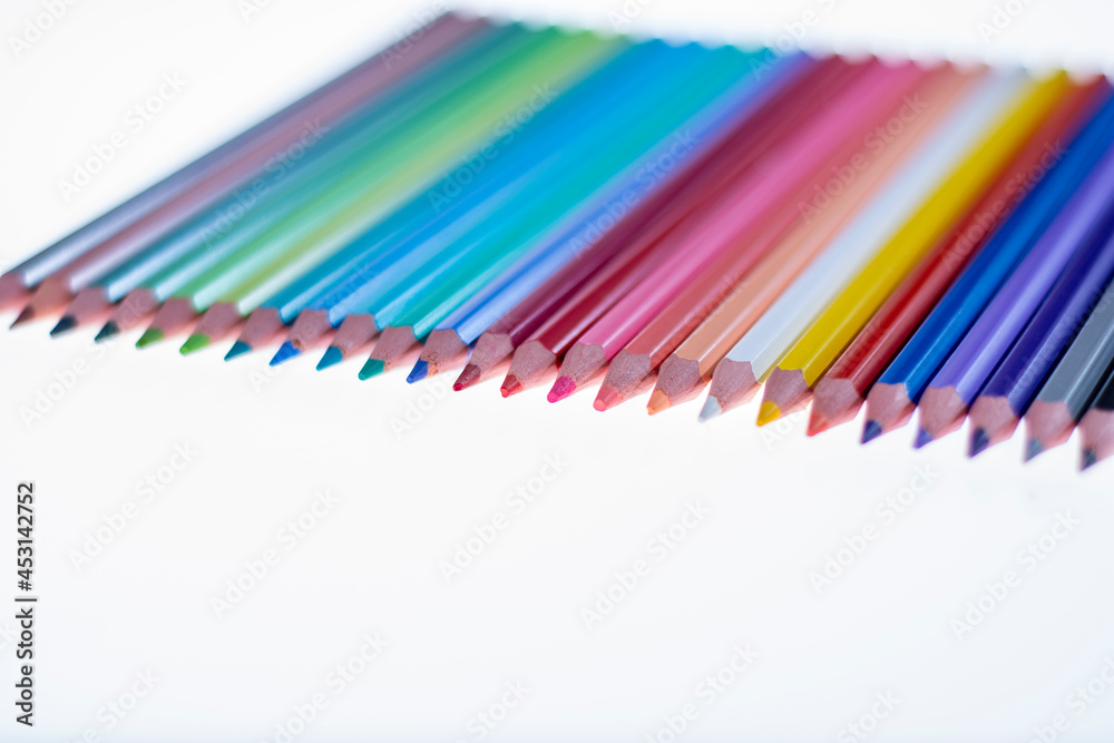 24 multicolored crayons on a white background, neatly arranged and sharpened. Hello School. 24 multicolored crayons on a white background, neatly arranged and sharpened. Hello School.