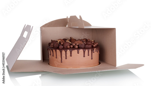 Cardboard takeaway cake box with chocolate cake inside isolated on white