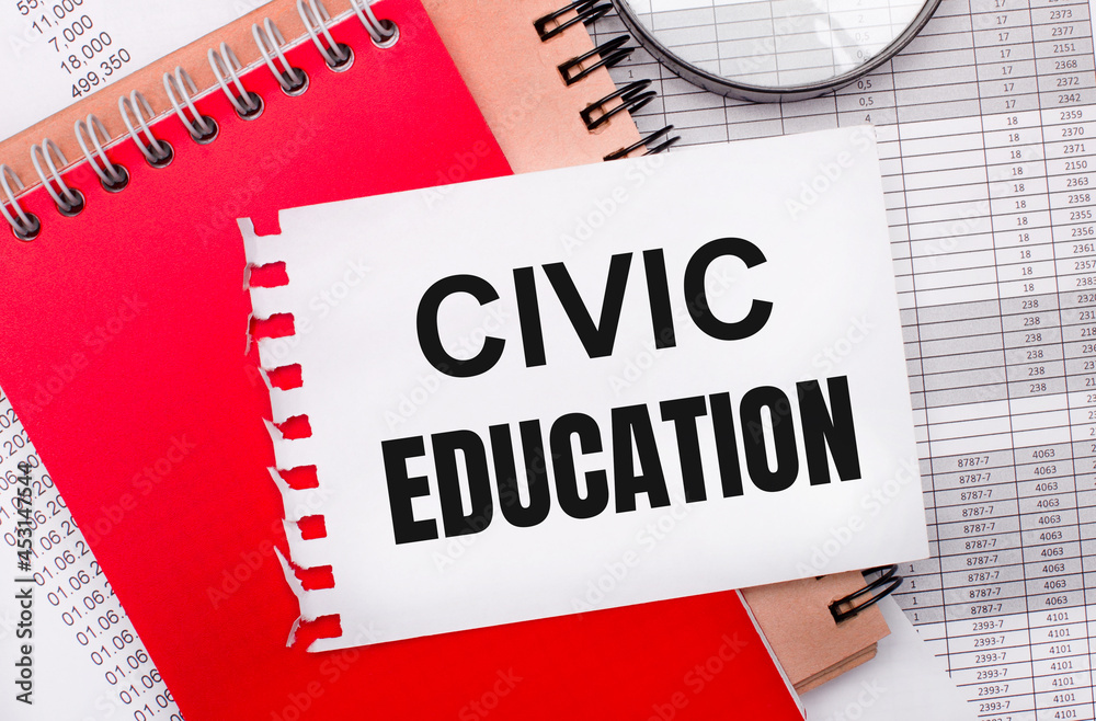On a light background - reports, a magnifying glass, brown and red notepads, and a white notepad with the text CIVIC EDUCATION. Business concept On a light background - reports, a magnifying glass, brown and red notepads, and a white notepad with the text CIVIC EDUCATION. Business concept