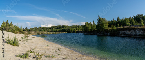 limestone mountains and calm blue groundwater lake in an old quarry