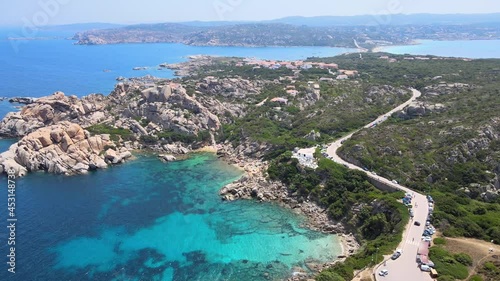 Panoramic views of the lagoon with blue sea water, rocks and a busy road nearby
