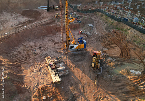 Deep foundation machine. Drilling rig and Pile driver at construction site. Pile driven into ground by vibrating hydraulic hammer. Foundations construction work. Ground drilling and Piling Contractor.