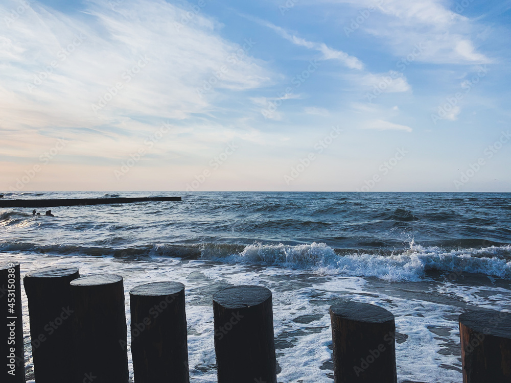 Breakwater construction in the sea, sea horizon, natural colors, romantic atmosphere Breakwater construction in the sea, sea horizon, natural colors, romantic atmosphere