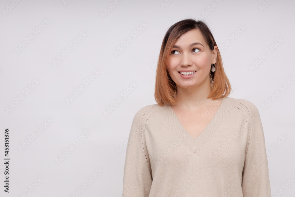 A contemplative woman with a happy dreamy expression on her face, focused on the side, thinking about a vacation after work, posing against a white background, coming up with an idea A contemplative woman with a happy dreamy expression on her face, focused on the side, thinking about a vacation after work, posing against a white background, coming up with an idea